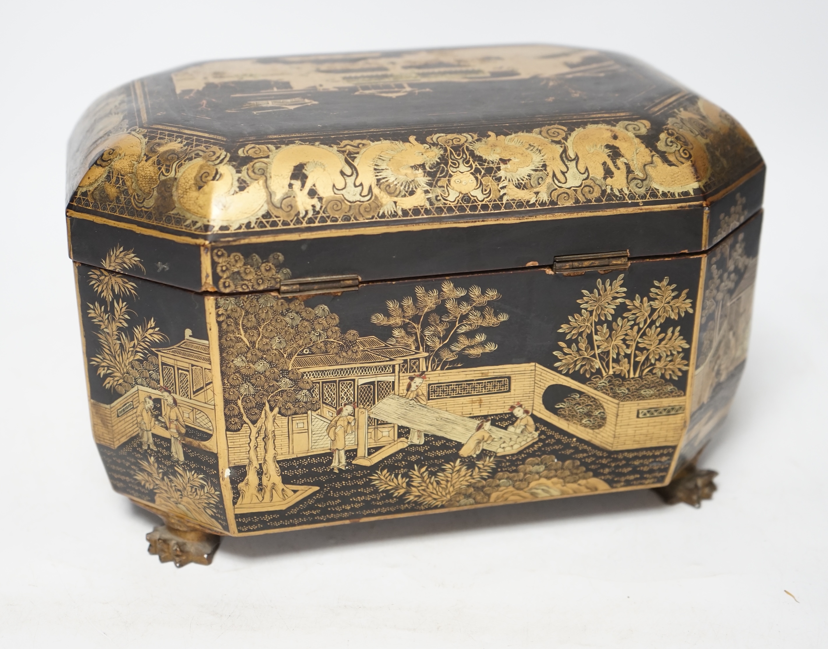 A mid 19th century Chinese export black and gold lacquer tea caddy, retaining engraved pewter tea canisters, raised on paw feet, 26cm wide. Condition - poor